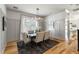 Bright dining room with hardwood floors, white wainscoting, and a modern chandelier at 1114 Georgia Blvd, Orlando, FL 32803