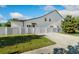 Charming two-story home featuring a white fence, well-maintained lawn, and a brick driveway at 1114 Georgia Blvd, Orlando, FL 32803