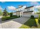 Elegant two-story home showcasing a brick driveway, manicured lawn, and classic architectural design at 1114 Georgia Blvd, Orlando, FL 32803