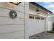 Close-up of a white garage door with decorative windows and a vintage-style 