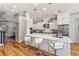 Modern white kitchen features quartz countertops, stainless steel appliances, and bar seating at 1114 Georgia Blvd, Orlando, FL 32803