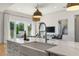 Bright kitchen features a farmhouse sink, marble countertops, and seamless flow to the living area and outdoor space at 1114 Georgia Blvd, Orlando, FL 32803