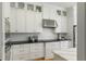 Bright kitchen showcases white cabinets, subway tile backsplash, stainless steel appliances, and black countertops at 1114 Georgia Blvd, Orlando, FL 32803