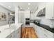 Modern kitchen with white cabinets, stainless steel appliances, a farmhouse sink, and black countertops at 1114 Georgia Blvd, Orlando, FL 32803