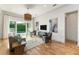 Stylish living room with hardwood floors, large windows, and outdoor access to the pool at 1114 Georgia Blvd, Orlando, FL 32803