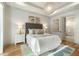 Bedroom featuring a large bed, tray ceiling, and an ensuite bathroom with white subway tile at 1114 Georgia Blvd, Orlando, FL 32803