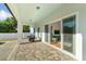 Covered patio with brick flooring and large sliding glass doors to the interior living spaces at 1114 Georgia Blvd, Orlando, FL 32803