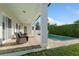 Covered outdoor seating area with a beautiful pool, brick paver decking and privacy landscaping at 1114 Georgia Blvd, Orlando, FL 32803