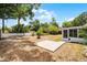 Spacious backyard featuring a patio, established trees, and a screened-in porch at 117 Exeter Ave, Longwood, FL 32750