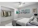 Serene bedroom showcasing a ceiling fan, closet, and large window providing natural light at 117 Exeter Ave, Longwood, FL 32750