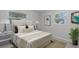 Bright bedroom features a comfortable bed, neutral decor, and natural light from two windows at 117 Exeter Ave, Longwood, FL 32750