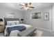 Cozy bedroom with a tufted headboard, ceiling fan, and a bench at the foot of the bed at 117 Exeter Ave, Longwood, FL 32750