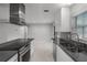 Kitchen featuring stainless steel appliances, modern cabinetry, stylish backsplash, and ample counter space at 117 Exeter Ave, Longwood, FL 32750