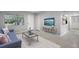 Bright living room with new paint, featuring an entertainment center and a view of the front yard at 117 Exeter Ave, Longwood, FL 32750