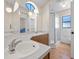 Bathroom with double sinks, large mirrors, and shower at 118 White Birch Dr, Kissimmee, FL 34743