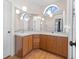 Bathroom with double sinks, large mirrors, and wood cabinetry at 118 White Birch Dr, Kissimmee, FL 34743