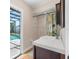 Modern bathroom with sink, vanity, and view of pool at 118 White Birch Dr, Kissimmee, FL 34743