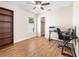 Bedroom with wood floor, ceiling fan, closet, and room for a study or a cozy reading nook at 118 White Birch Dr, Kissimmee, FL 34743