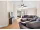 Inviting living room with a large sectional sofa, hardwood floors, and a television, creating a cozy atmosphere at 118 White Birch Dr, Kissimmee, FL 34743