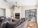 Comfortable living room with hardwood floors, a ceiling fan, and sliding glass doors to the outdoor patio at 118 White Birch Dr, Kissimmee, FL 34743