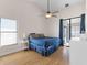 Bright main bedroom featuring a fan, window, sliding glass doors, and access to the lanai at 118 White Birch Dr, Kissimmee, FL 34743