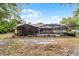 Large backyard featuring a screened patio and ample space for outdoor activities and entertaining at 1201 Groveland Dr, Chuluota, FL 32766