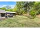 Expansive backyard with a screened-in patio and lush greenery, perfect for outdoor enjoyment at 1201 Groveland Dr, Chuluota, FL 32766