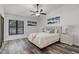 Bright bedroom featuring a plush bed, stylish artwork, and a large window with natural light at 1201 Groveland Dr, Chuluota, FL 32766