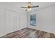Bedroom with a ceiling fan, double closets, and a window, perfect for relaxation at 1201 Groveland Dr, Chuluota, FL 32766