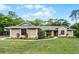 Charming single-story home with manicured lawn, neatly trimmed shrubbery, and a covered front entrance at 1201 Groveland Dr, Chuluota, FL 32766