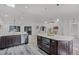 Open-concept kitchen with an island featuring a microwave and a bright and spacious living area at 1201 Groveland Dr, Chuluota, FL 32766