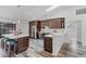 Modern kitchen with wood cabinets, stainless steel appliances, and a bright island with counter seating at 1201 Groveland Dr, Chuluota, FL 32766