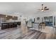 Spacious open-concept layout with a modern kitchen island and comfortable living room area, filled with light at 1201 Groveland Dr, Chuluota, FL 32766
