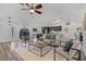 Open-concept living room with high ceilings, neutral furniture, and wood-look floors, filled with natural light at 1201 Groveland Dr, Chuluota, FL 32766