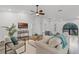 Bright living room with white walls, modern furnishings, and a large arched window for ample natural light at 1201 Groveland Dr, Chuluota, FL 32766