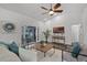 Inviting living room with neutral decor, wood-look floors, and access to the outdoor area through sliding doors at 1201 Groveland Dr, Chuluota, FL 32766