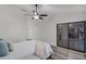 Main bedroom with a ceiling fan, closet access, and views of the outdoor entertainment space at 1201 Groveland Dr, Chuluota, FL 32766