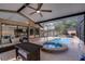 Back patio features an in-ground spa and outdoor lounge furniture under a screened enclosure at 1201 Groveland Dr, Chuluota, FL 32766