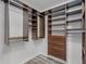 Organized walk-in closet featuring built-in shelving, drawers, and ample storage space at 1201 Groveland Dr, Chuluota, FL 32766