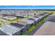Aerial view of neighborhood with homes featuring screened in patios and community amenities at 1293 Emerald Row, Clermont, FL 34714