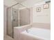 The bathroom features a soaking tub and a walk-in shower with a glass enclosure at 1293 Emerald Row, Clermont, FL 34714