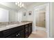 The bathroom has double sinks with granite countertops and a glass-enclosed shower, blending style and functionality at 1293 Emerald Row, Clermont, FL 34714