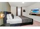 This bedroom includes a comfortable bed, contemporary design, and a flatscreen TV, blending style and relaxation at 1293 Emerald Row, Clermont, FL 34714