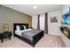 Modern bedroom featuring a luxurious bed, stylish decor, and a flatscreen TV, creating a relaxing retreat at 1293 Emerald Row, Clermont, FL 34714