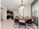 Dining area with decorative chandelier adjacent to modern, well-equipped kitchen at 1293 Emerald Row, Clermont, FL 34714