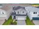 Two story home with manicured landscaping, a gray exterior, and a two car garage in a community at 1293 Emerald Row, Clermont, FL 34714