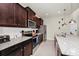 Modern kitchen featuring dark cabinets, stainless steel appliances and granite countertops at 1293 Emerald Row, Clermont, FL 34714