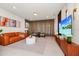 Bright living room with modern decor, stylish furniture, and a large television at 1293 Emerald Row, Clermont, FL 34714