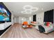 Spacious living room featuring modern furniture, hardwood floors, and stylish lighting at 1293 Emerald Row, Clermont, FL 34714