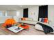 Bright living room with modern decor, stylish seating, and sleek hardwood floors at 1293 Emerald Row, Clermont, FL 34714